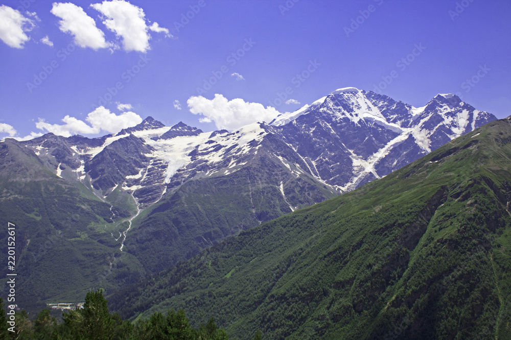 Glacier Seven and pastoral view on mountains in valley near Elbrus