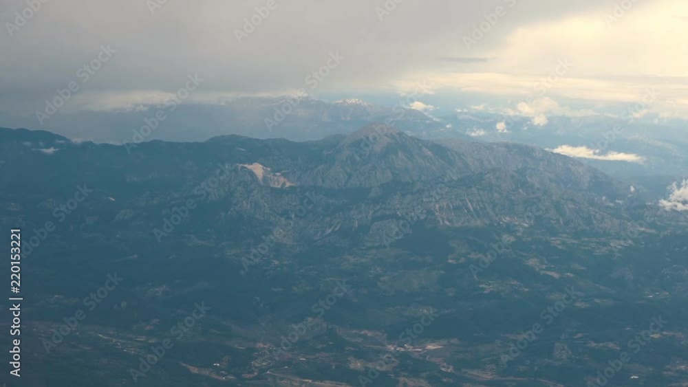 Aerial View. Flying over the high mountains in beautiful clouds Aerial View. Flying over the high mountains in beautiful clouds