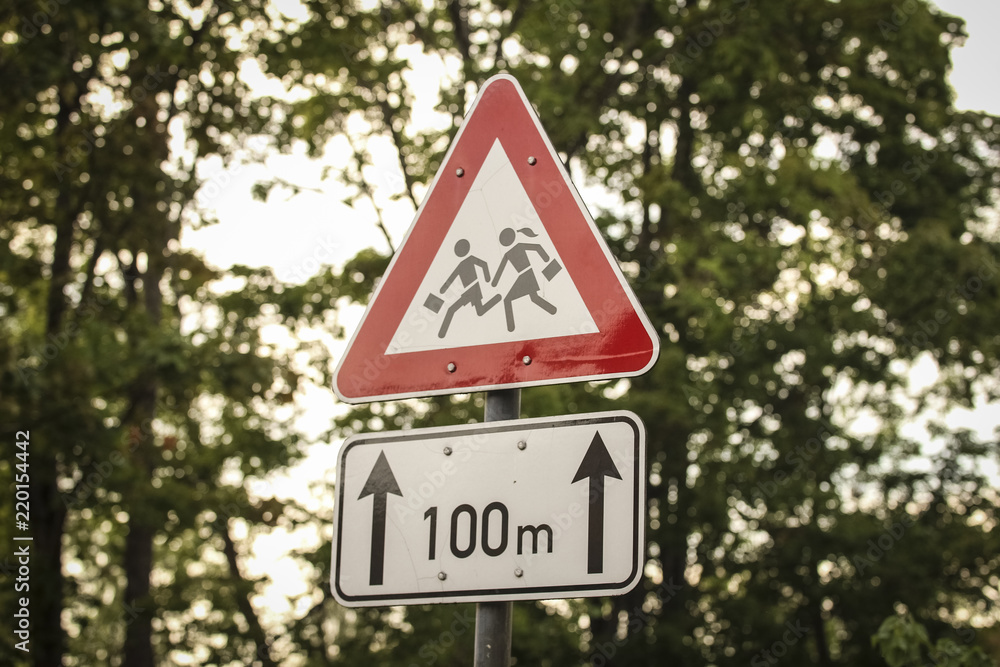 Road sign with image of the children who run across the road Road sign with image of the children who run across the road