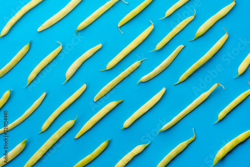Creative layout made of yellow beens on blue background. Flat lay. Food concept.