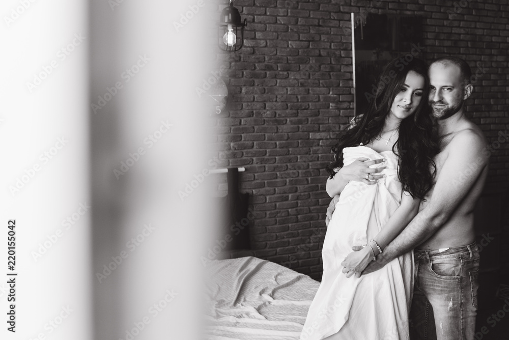 Couple in love pregnant lie in bed cuddling, waiting for baby Couple in love pregnant lie in bed cuddling, waiting for baby