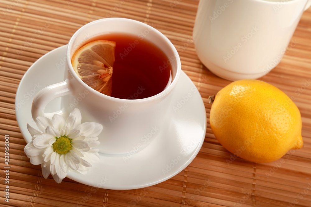 Tea with lemon slice, whole lemon and flower Tea with lemon slice, whole lemon and flower