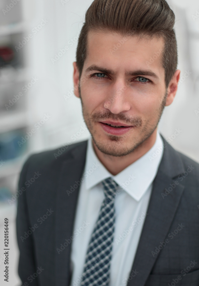 close up.portrait of a successful businessman on the background of the office close up.portrait of a successful businessman on the background of the office