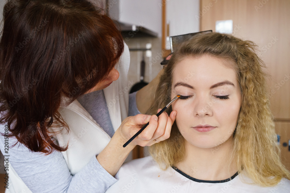 Woman getting make up done by artist Woman getting make up done by artist