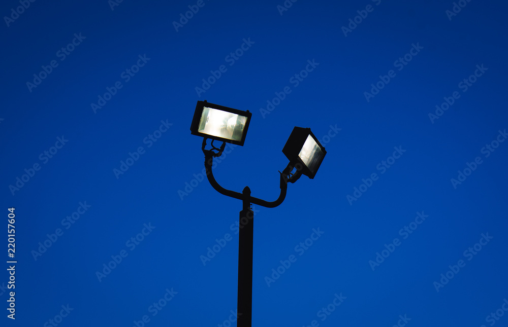 Silhouette of street lamp with bulbs on Silhouette of street lamp with bulbs on