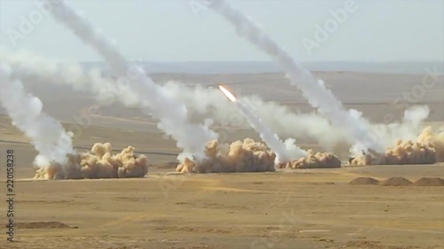 Truck based anti aircraft missile launchers fire in the desert. photo