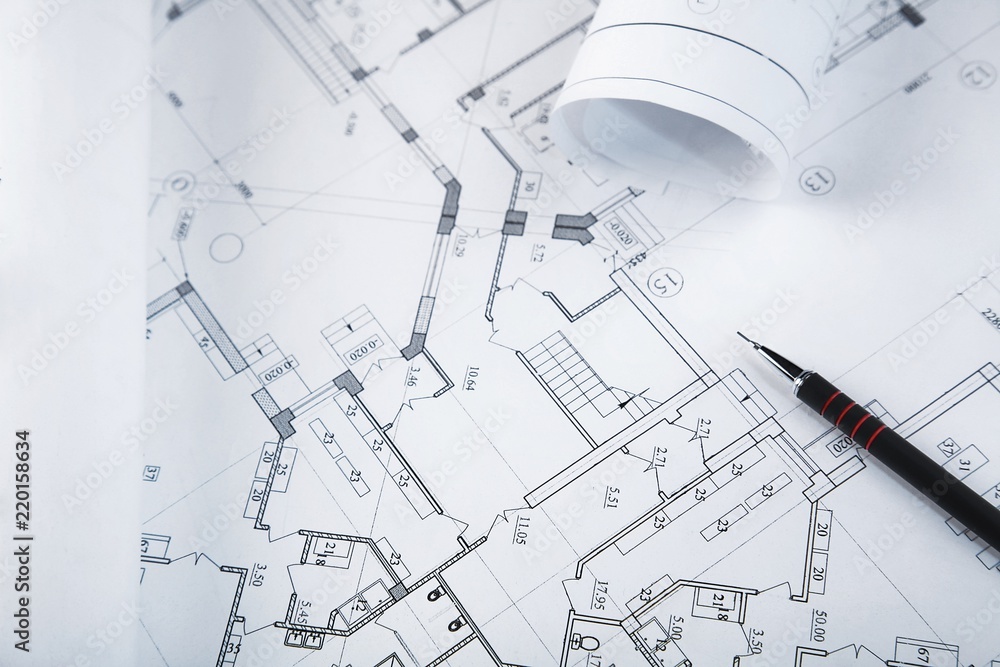Blueprints with a drafting pencil on top of them Blueprints with a drafting pencil on top of them