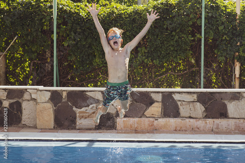 child jumps into swimming pool