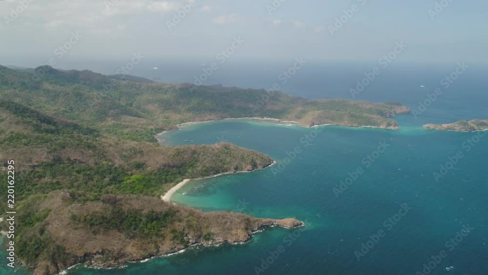 Aerial view of coast with beaches, lagoons and coral reefs. Neela cove, Limbones. Coast ocean with tropical beach, turquoise water. Tropical landscape in Asia. Philippines, Luzon. Aerial view of coast with beaches, lagoons and coral reefs. Neela cove, Limbones. Coast ocean with tropical beach, turquoise water. Tropical landscape in Asia. Philippines, Luzon.