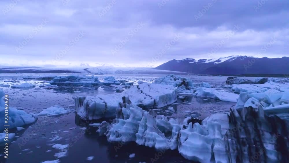 Drone aerial over icebergs in a glacial bay, suggest global warming in the Arctic at Jokulsarlon glacier lagoon, Iceland, night. Drone aerial over icebergs in a glacial bay, suggest global warming in the Arctic at Jokulsarlon glacier lagoon, Iceland, night.