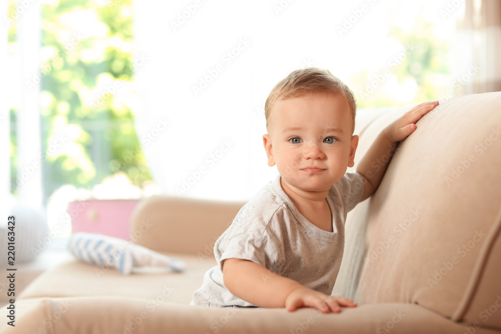 Adorable little baby on sofa at home Adorable little baby on sofa at home