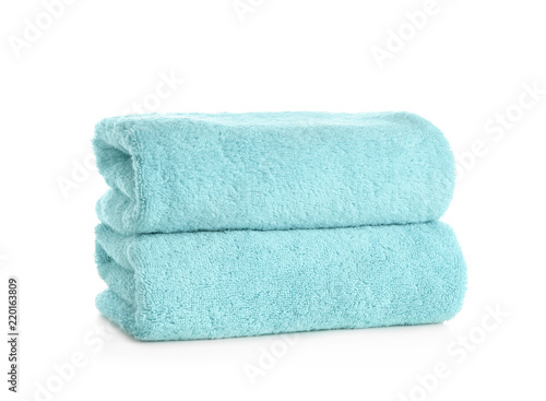 Stack of clean soft towels on white background