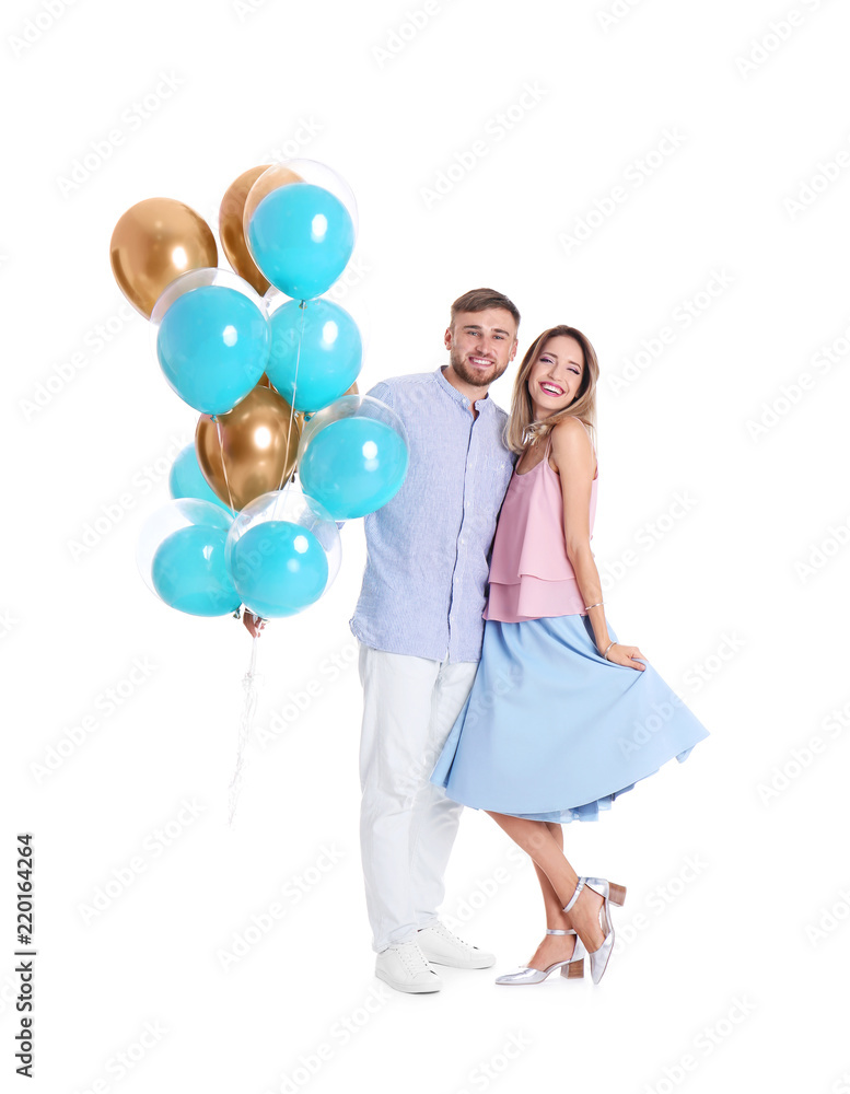 Young couple with air balloons on white background