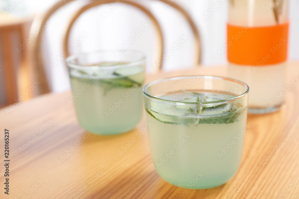 Glasses with natural lemonade on table indoors Glasses with natural lemonade on table indoors