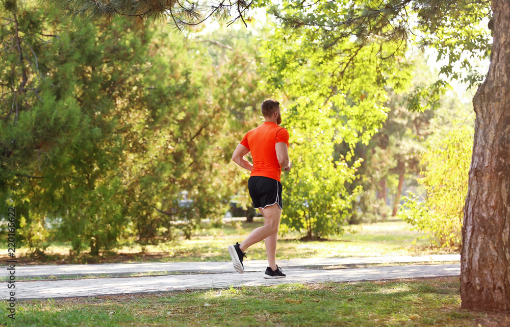 Young man running in park on sunny day Young man running in park on sunny day