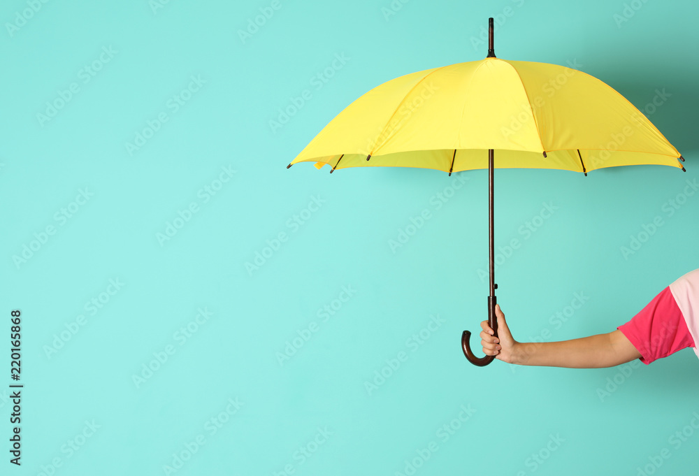 Fototapeta premium Woman holding beautiful umbrella on color background with space for design