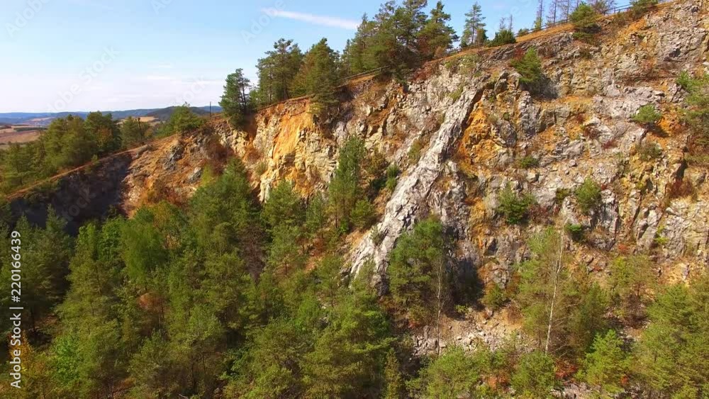The Golden Horse Mountain with Koneprusy caves in nature reserve of Czech Karst. Camera flight over a natural monument in Czech Republic. Nature in Central Europe. The Golden Horse Mountain with Koneprusy caves in nature reserve of Czech Karst. Camera flight over a natural monument in Czech Republic. Nature in Central Europe.