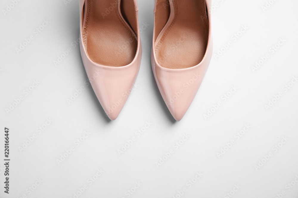 Pair of beautiful shoes and space for text on light background, top view Pair of beautiful shoes and space for text on light background, top view