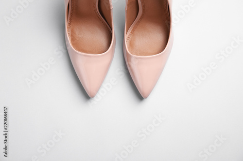 Pair of beautiful shoes and space for text on light background, top view