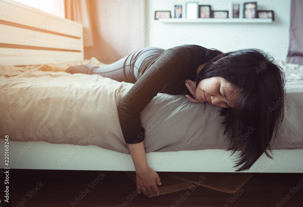 Asian woman bent and searching document under bed lost thing Asian woman bent and searching document under bed lost thing
