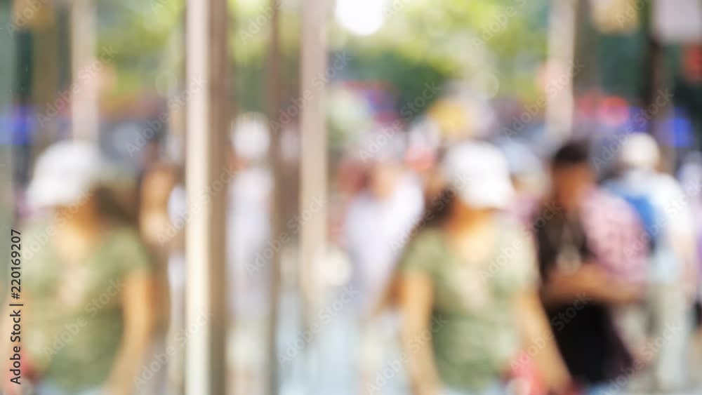 People walking on street out of focus reflection in window People walking on street out of focus reflection in window