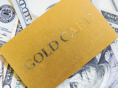 Gold card on the background of dollar bills