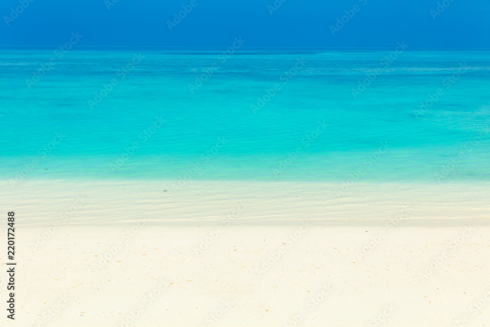 Fototapeta premium Blue sea water surface, clear sky and sandy seashore
