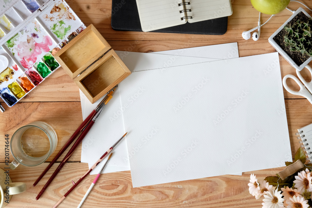 Top view wood desk of an artist with lots of stationery object. Student workspace and copy space