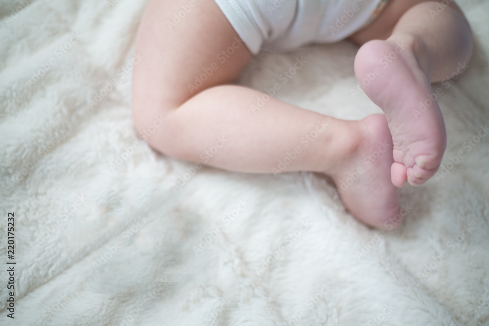 baby's legs and bottom on white blanket baby's legs and bottom on white blanket