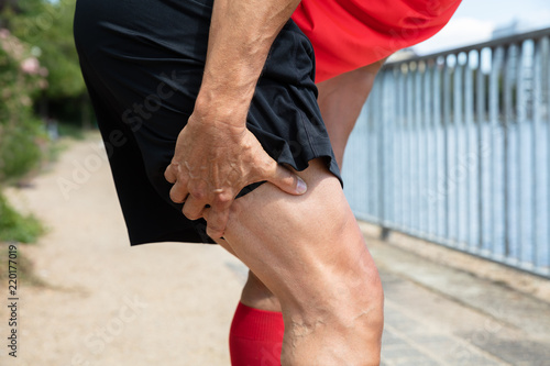 Slika na platnu Runner Holding His Injured Leg