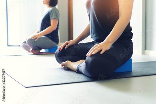 Young fat woman practicing yoga with namaste behind the back.working out, wearing sportswear. and relax.