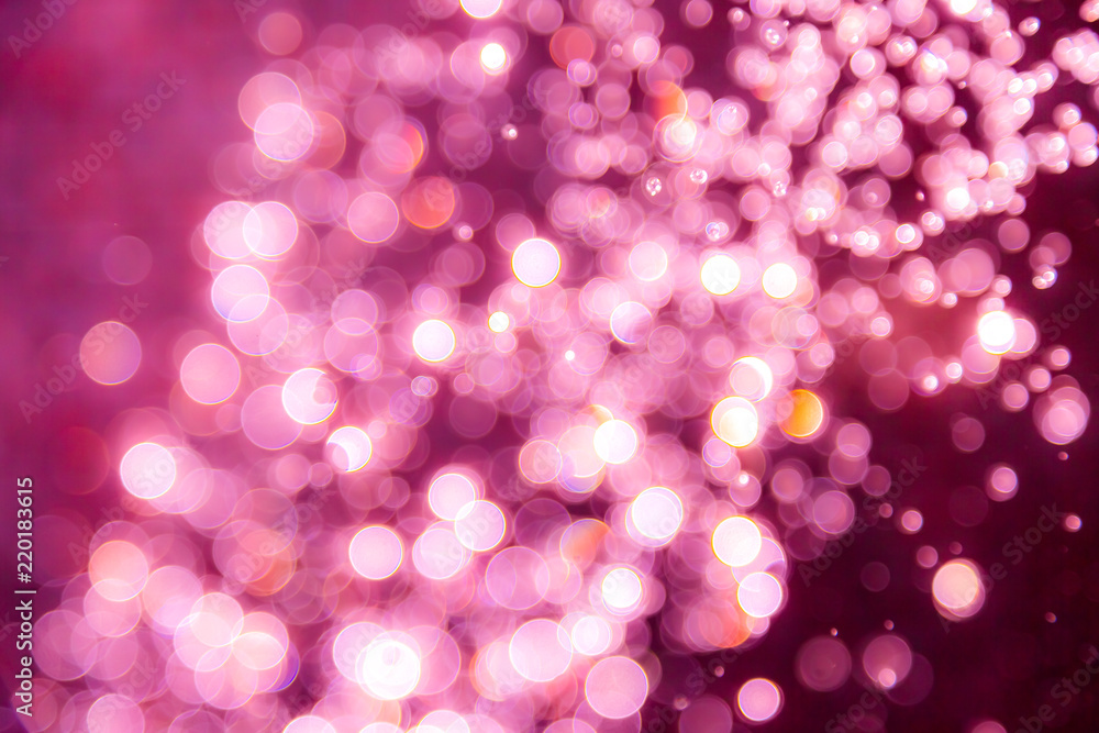 Pink bokeh of water drops levitating in the air reflection