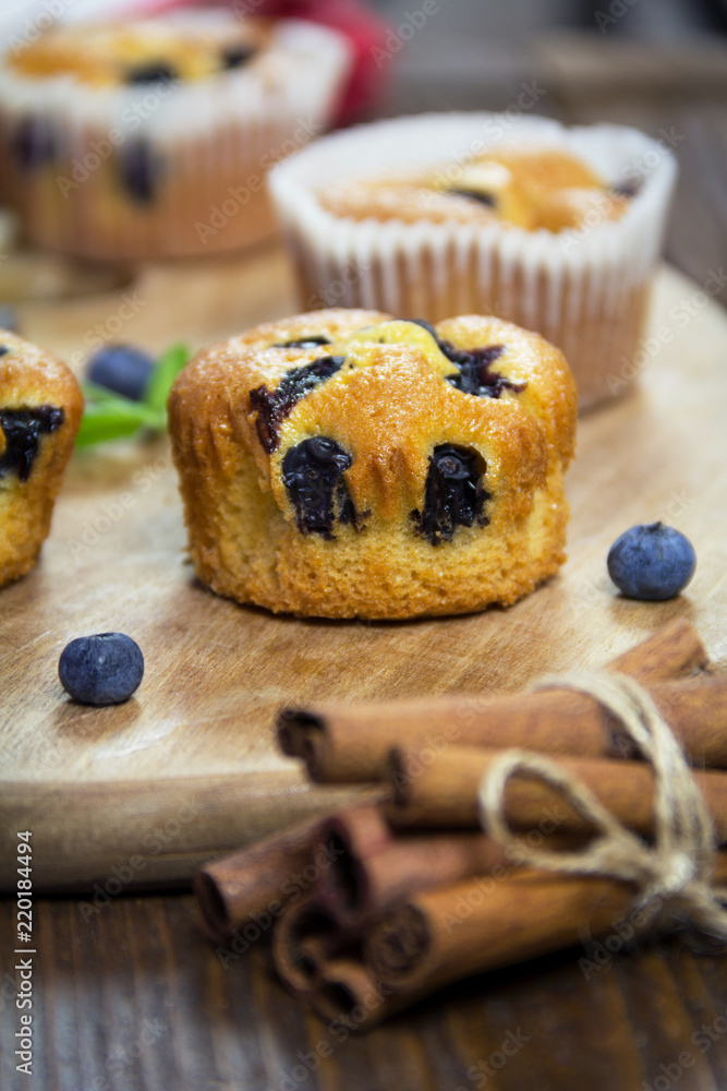 Muffins with blueberries, chocolate and cinnamon on a wooden board. Sweet dessert Muffins with blueberries, chocolate and cinnamon on a wooden board. Sweet dessert