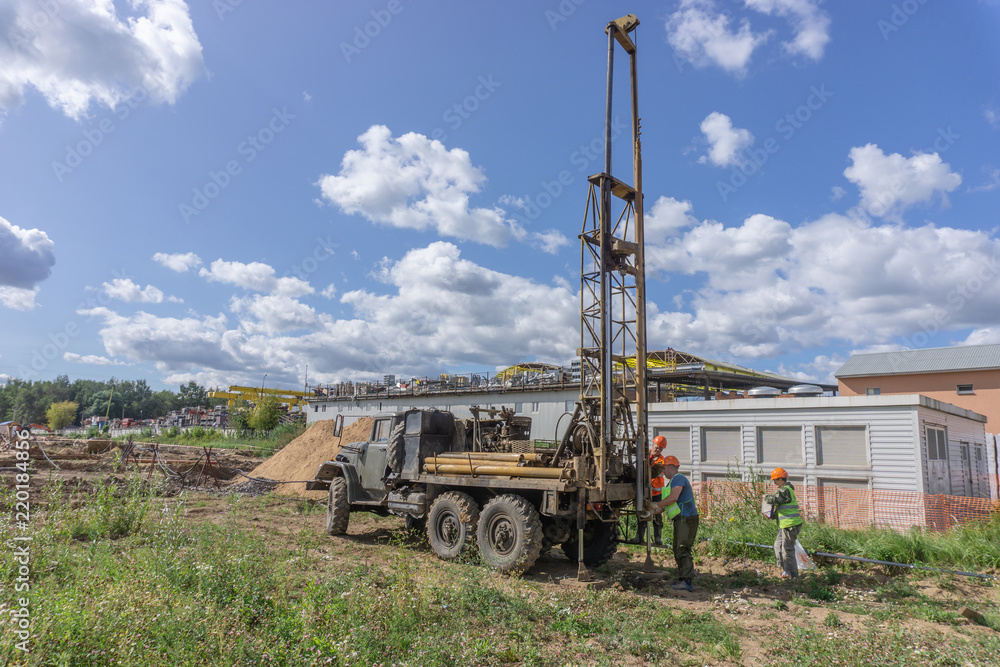 Fototapeta premium Khimki, Russia - August 24, 2018: Drilling machine, ecologist and soil samples at the construction site