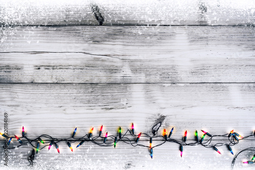 Christmas lights bulb decoration on white wood plank. Merry Christmas and New Year holiday background. vintage color tone.