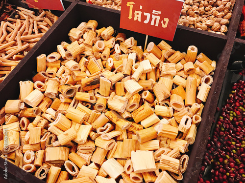 Dried Lu gen or Reed rhizome or Rhizoma phragmitis. (Thai language depicted in the photo is its pronunciation of Chaozhou by Thai spelling) photo