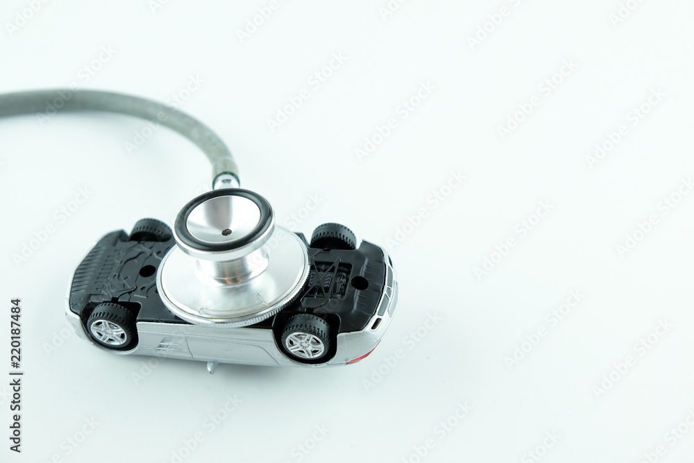 Stethoscope checking up the car on white background, Concept of car check up, repair and maintenance.. Stethoscope checking up the car on white background, Concept of car check up, repair and maintenance..