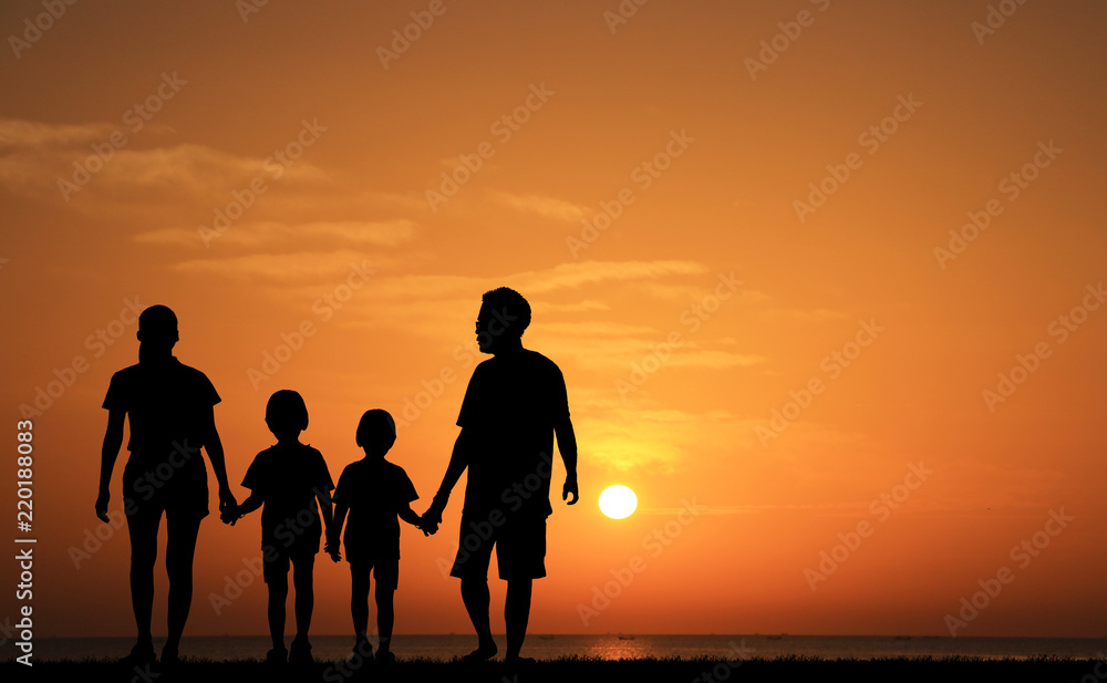silhouette of family on the beach at  sunrise time