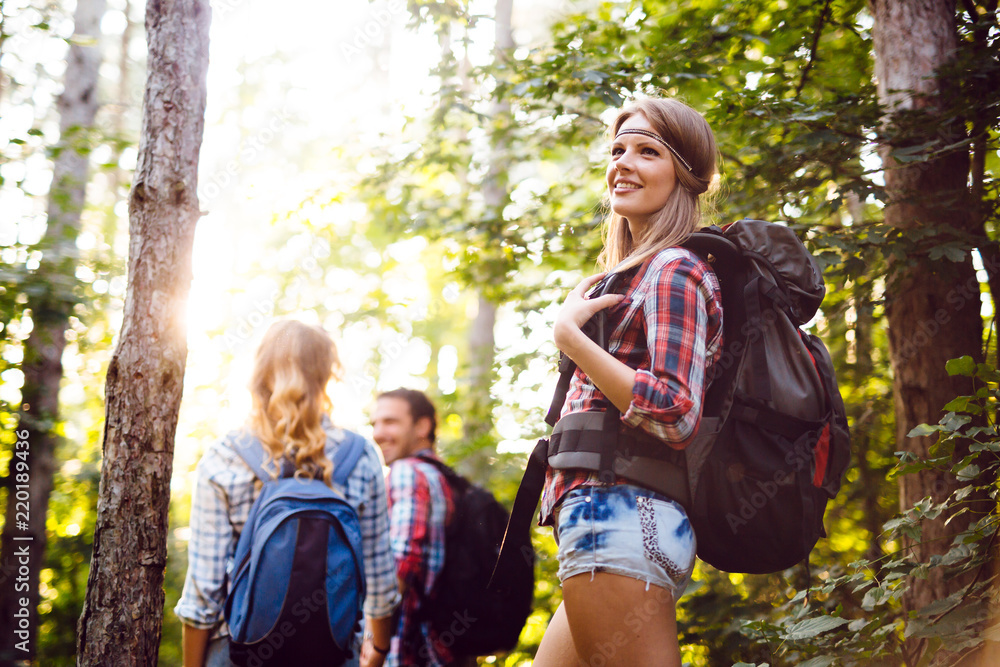 Group of backpacking hikers going for forest trekking Group of backpacking hikers going for forest trekking