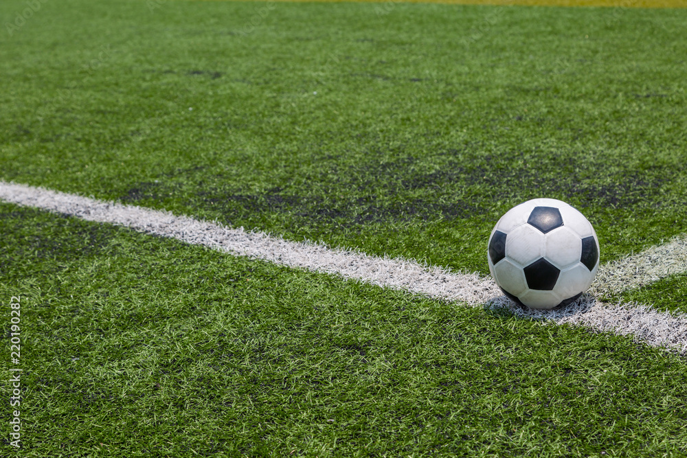 soccer ball on the white line on green soccer field grass soccer ball on the white line on green soccer field grass