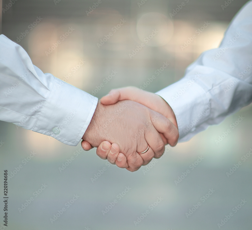 closeup. handshake business people in blurred background. closeup. handshake business people in blurred background.