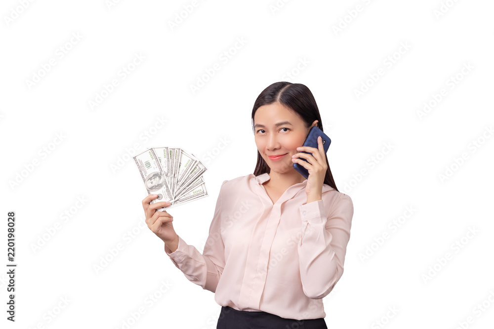 Asian beautiful woman holding banknote money in hand and mobile phone in another hand isolated on white background with clipping path. commercial business by phone concept Asian beautiful woman holding banknote money in hand and mobile phone in another hand isolated on white background with clipping path. commercial business by phone concept