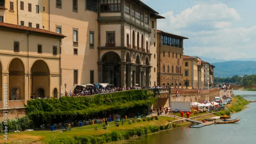 Telephoto shot of the Arno River, in Florence, Tuscany, Italy and traditional shops alongside its banks. Florence is considered the birthplace of the Renaissance Telephoto shot of the Arno River, in Florence, Tuscany, Italy and traditional shops alongside its banks. Florence is considered the birthplace of the Renaissance
