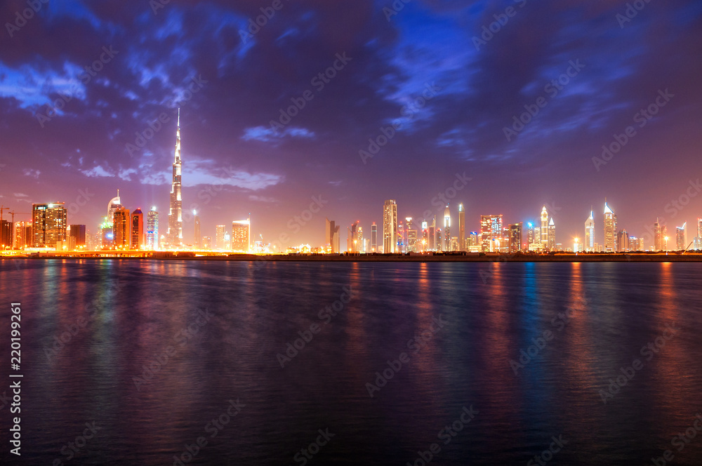 Beautiful night dubai downtown skyline. Reflection of skyscrapers in Business Bay area, Dubai, United Arab Emirates