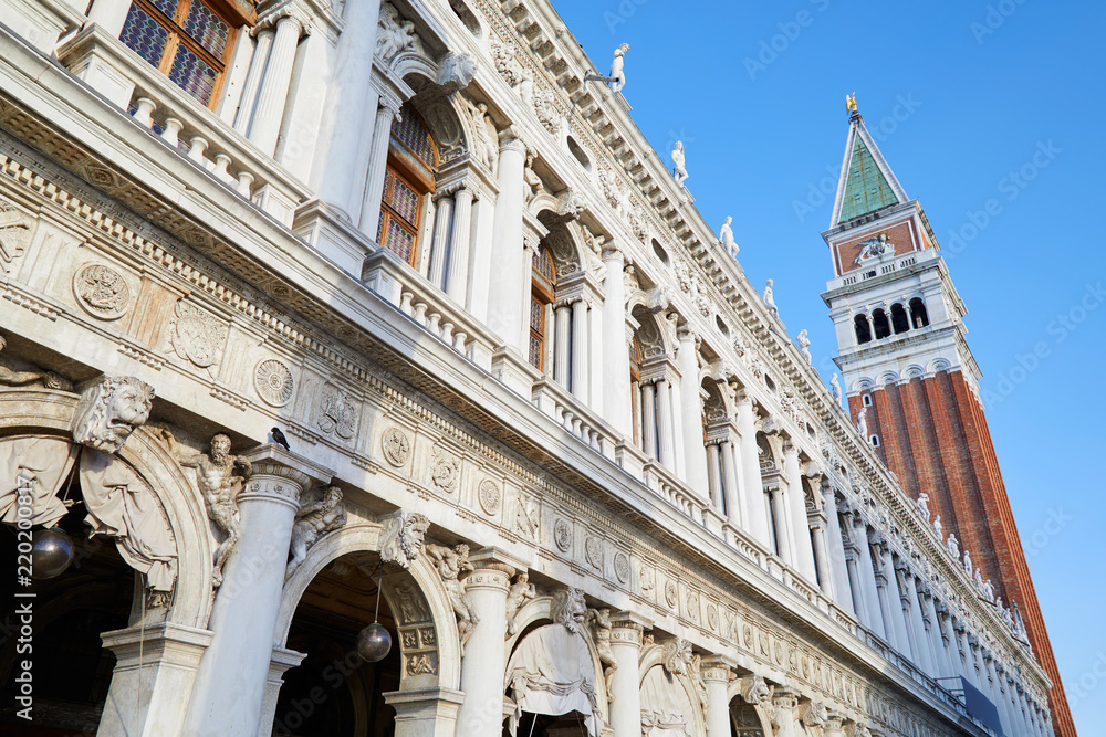 National Marciana library facade and San Marco bell tower, clear blue sky in Venice, Italy