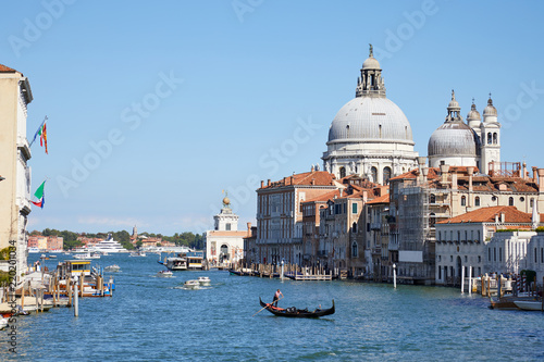 Venice, Saint Mary of Health basilica and Grand Canal with gondola in Italy in a sunny summer day