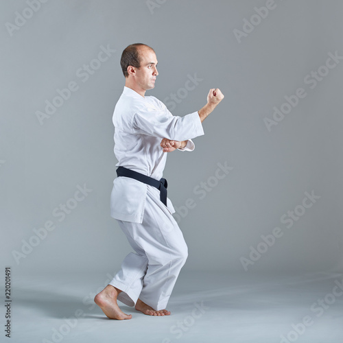 Young athlete trains formal karate exercises