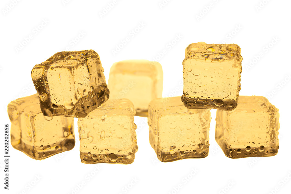 Golden ice cubes on white background.