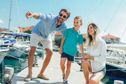 Happy family having fun, enjoying the summer time by the sea.