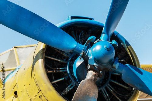 engine, fuselage and propeller of the airplane against the blue sky